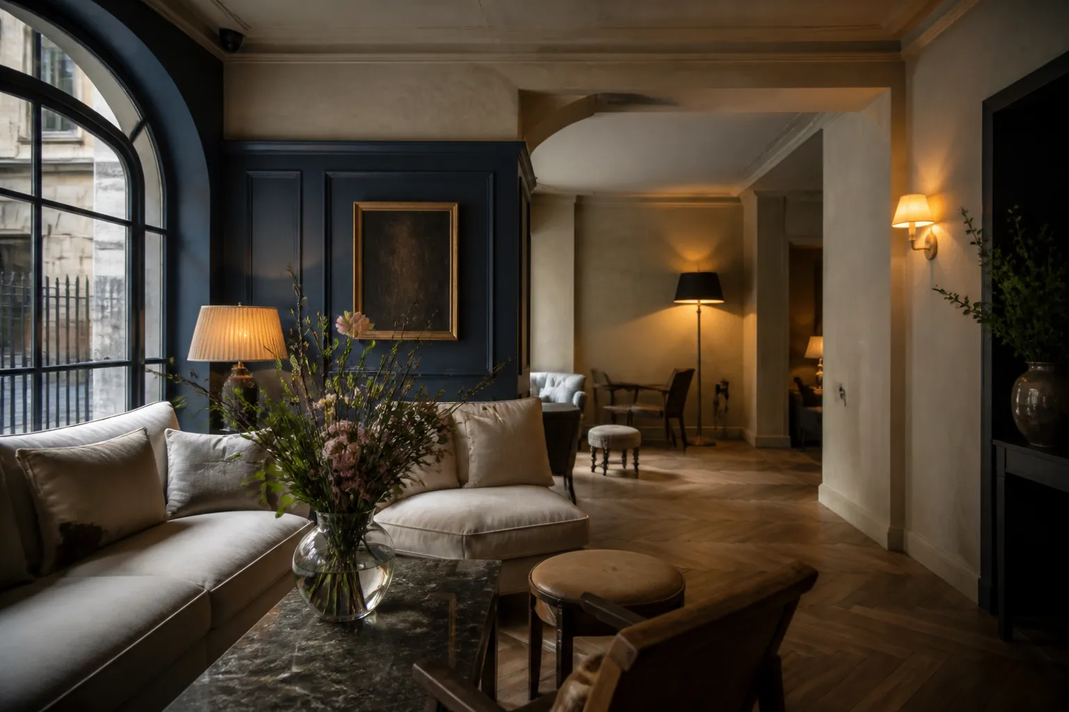 A boutique hotel lobby dressed with linen, brass, and fresh flowers.
